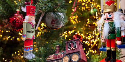 Christmas Trees decorations, handmade, personalised and handcrafted traditional decorations. Nutcrackers, and vintage trains hanging on a Christmas tree.