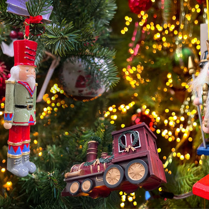 Christmas Trees decorations, handmade, personalised and handcrafted traditional decorations. Nutcrackers, and vintage trains hanging on a Christmas tree.