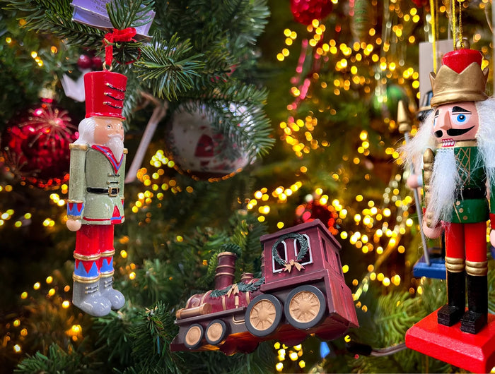 Christmas Trees decorations, handmade, personalised and handcrafted traditional decorations. Nutcrackers, and vintage trains hanging on a Christmas tree.