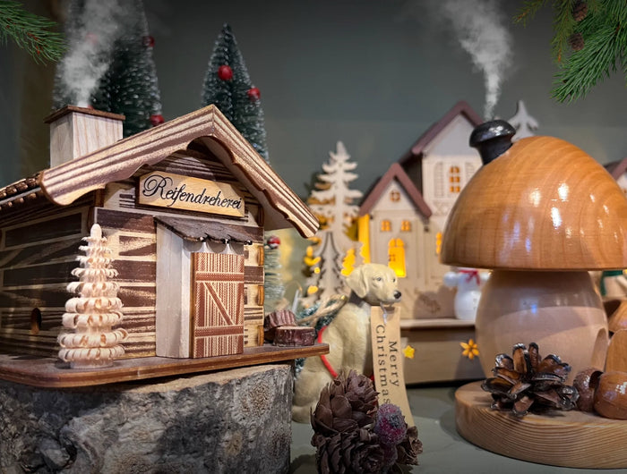 Traditional wooden, hand carved German incense burners, a mushroom and Ski Chalet. 